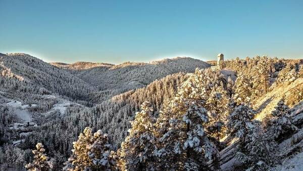 Mine shaft head frame set in snowy mountain scene